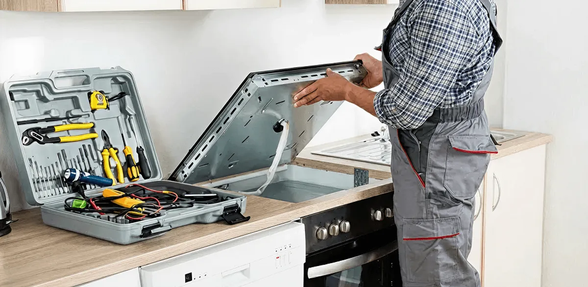 Handyman repairing a cooktop and checking wiring connections in Eugene, OR
