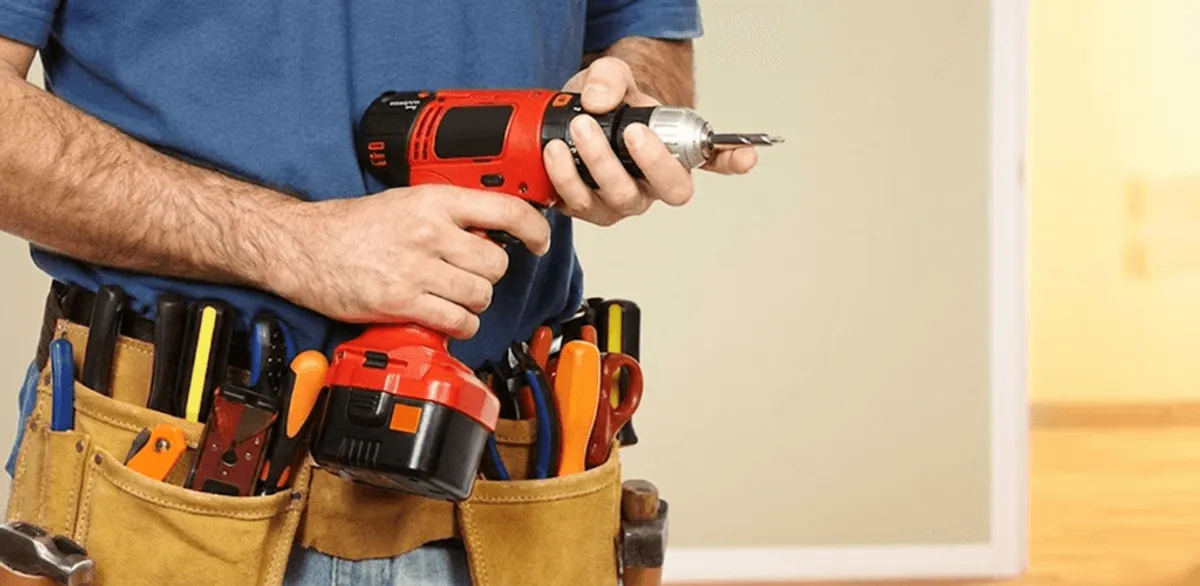 Handyman holding a power drill for home repairs and installations in Eugene, OR